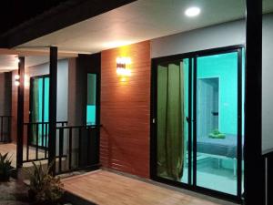 a house with a balcony with sliding glass doors at KOOK BUNGALOW in Ko Mook