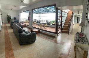a large living room with couches and a balcony at Hotel Shalom in Riobamba