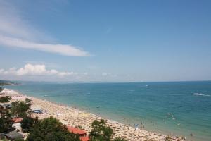 a beach with a lot of people in the water at Bonita Hotel in Golden Sands