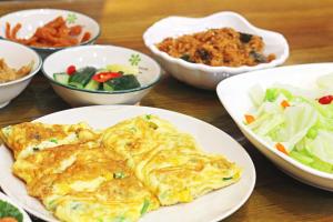 a table with plates of food and bowls of food at Sun Moon Lake Dream House B&B in Yuchi