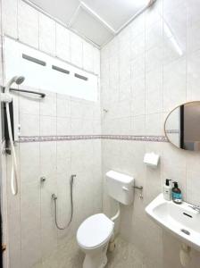 a white bathroom with a toilet and a sink at 8min Port Dickson beach 17pax Pet Friendly in Port Dickson