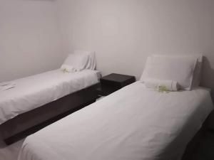 two beds sitting next to each other in a room at K4 Bed and Breakfast in Maseru +34 photos