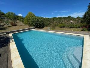 a large swimming pool with blue water at Superb villa with private pool in Banne