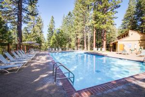 a large swimming pool with chairs and trees at Kingswood Village 2 in Kings Beach