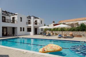 a swimming pool with a raft in the middle at The Corner House at Gennadi Court in Gennadi