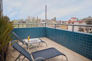 a balcony with chairs and a table on a roof at Blue Tree Towers Caxias do Sul in Caxias do Sul