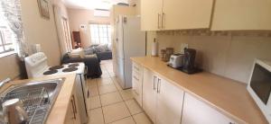 a kitchen with a sink and a stove at Nature Cottage in Marloth Park