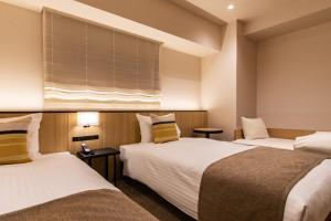 Postel nebo postele na pokoji v ubytování Hotel Vista Fukuoka Nakasu-Kawabata