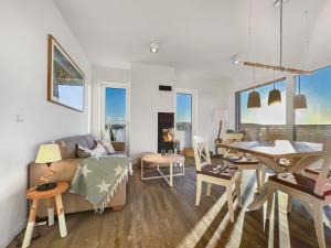 a living room with a couch and a table at Penthouse - Sterntaucher in Glowe
