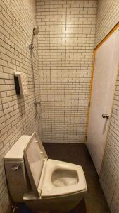 a bathroom with a toilet in a stall at Fishtail Hostel Phuket in Karon Beach