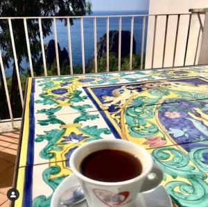 a cup of coffee sitting on top of a table at Villacore Luxury Guest House in Capri