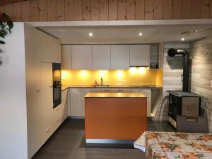 a kitchen with white cabinets and a stove at Ferienwohnung Stalden in Lütschental