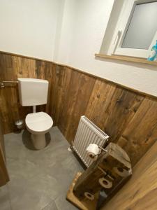 a bathroom with a toilet and a radiator at Ferienwohnung Wildkogelblick in Bramberg am Wildkogel