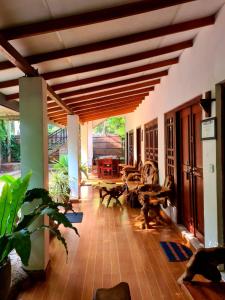 a large living room with a wooden ceiling at Habarana Dulwan Guest House in Habarana