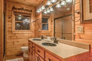 a bathroom with two sinks and a toilet in a log cabin at Love You Deerly in Morganton +44 photos