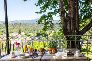 a table with food sitting on top of a balcony at L'Ortensia in Saint-Gervais-sur-Mare