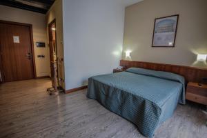 Postel nebo postele na pokoji v ubytování Hotel Petra