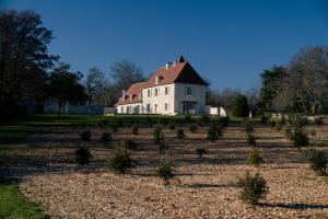 an old house in a field of plants at Domaine Truffier du Grand Merlhiot in Savignac-les-Églises