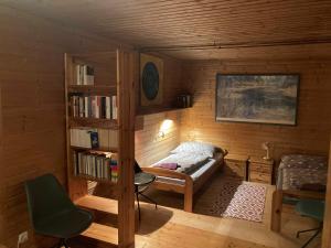 a small room with a bed and a book shelf at Sport- und Seminarhaus Walsertal in Thüringerberg