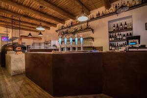 a bar with several wine bottles on the counter at ZEROPENSIERI B&B in Agropoli