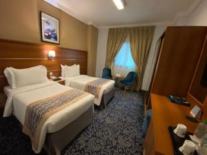 Postel nebo postele na pokoji v ubytování Saraya Harmony Hotel C + 37 fotografií