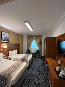 Postel nebo postele na pokoji v ubytování Saraya Harmony Hotel C