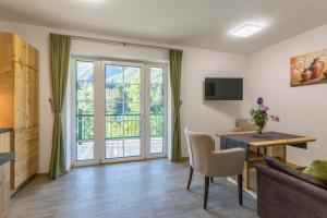 a living room with a couch and a table and a window at Appartement Hess Hinterstoder in Hinterstoder