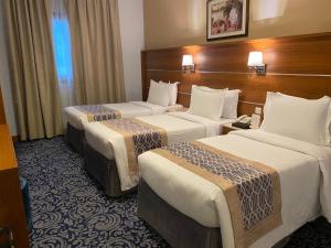 Postel nebo postele na pokoji v ubytování Saraya Harmony Hotel C
