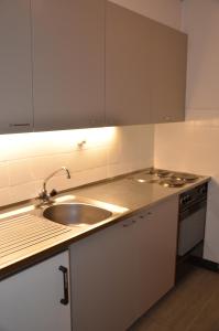 a kitchen with a sink and a stove at Immeuble Les Ecureuils in Les Collons +3 photos