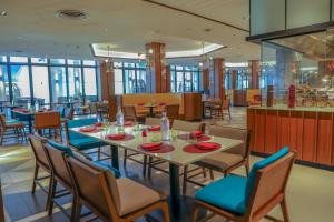a dining room with a table and chairs at Hard Rock Hotel Desaru Coast in Desaru
