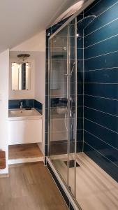 a bathroom with a glass shower and a sink at La Houache Chambres d'Hôtes in Le Pellerin