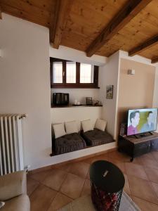 a living room with a couch and a flat screen tv at Il Pozzo in Tremezzo