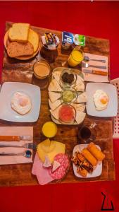 a wooden table with plates of food on it at B&B Una Habitación Propia in Valencia