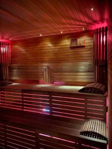 a sauna with red lights in a room at ForrestVila in Karačiūnai