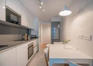 a kitchen with a table and a white counter top at Goizeder apartment by People Rentals in Bilbao