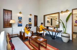 a man and a woman sitting in a room at Viveda Wellness Resort in Nashik