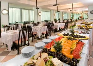 a long table with food on it in a restaurant at Hotel Madison - Cattolica in Cattolica