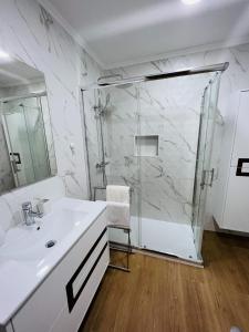 a white bathroom with a shower and a sink at Beautiful Apartment - Family and Group of Friends in Póvoa de Santa Iria +65 photos