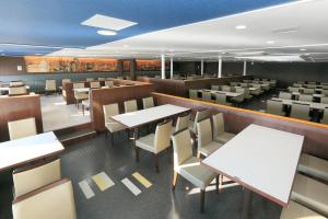 a dining room with white tables and chairs at Meimon Taiyo Ferry 1st sailing from Kitakyushu to Osaka in Kitakyushu