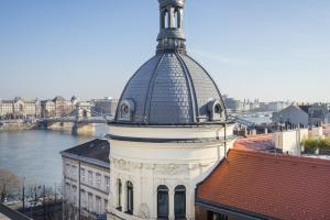 a building with a dome on top of it at Butik Apartments, by BQA in Budapest