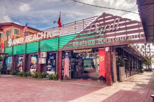 a store front of a seafood restaurant on a street at Sandy Beach Resort By Casa Loma in Pantai Cenang