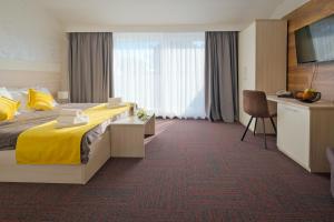 a hotel room with a bed and a desk at Hotel Bor in Krk