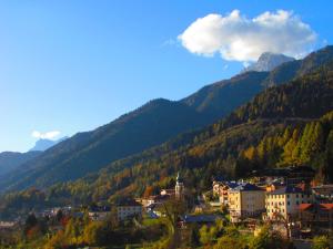 a town in a valley with mountains in the background at Hotel Belvedere Dolomiti in Pieve di Cadore