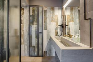 a bathroom with a sink and a shower at Butik Apartments, by BQA in Budapest