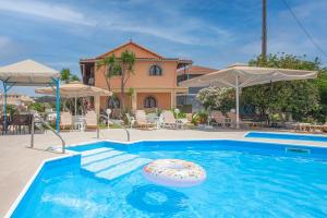 a swimming pool with an inflatable at Lord Complex in Agios Georgios