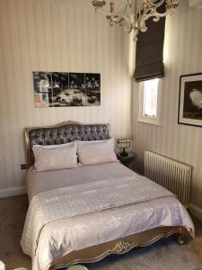 a bedroom with a bed and a chandelier at Apartment 6 Rowntree House in York