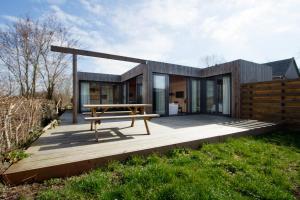 een modern huis met een picknicktafel op een terras bij Dunes of Egmond in Egmond-Binnen