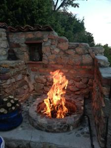 a brick oven with a fire in it at Villa Panorama Struga, Elen Kamen in Struga