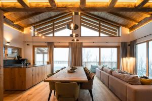 a living room with a table and a couch at Das Chalet. in Mühlbach am Hochkönig