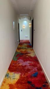 un pasillo con una alfombra colorida en el suelo en Roseau Hotel And Spa, en Gondar